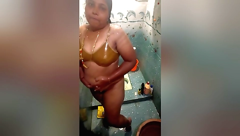 Cute indian woman with perfect body showers in a private space
