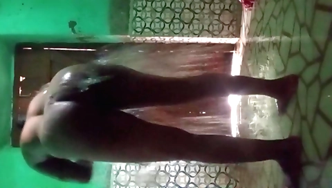 Brunette in stockings and a pink dress goes in the shower