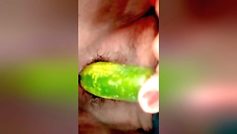 Solo female takes a bite of a cucumber and enjoys her favorite toy