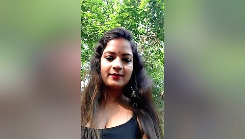 Cooker in white blouse cooking in an outdoor kitchen