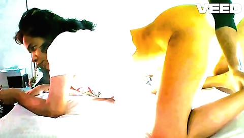 Indian brunette in the poses of dancing on a yoga mat